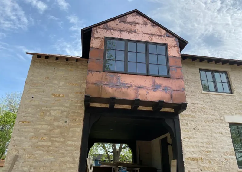 Copper metal panel facade on a stone building for Skylight Installation in Destrehan