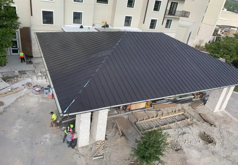 Metal roofing installation team working on a commercial building in Destrehan