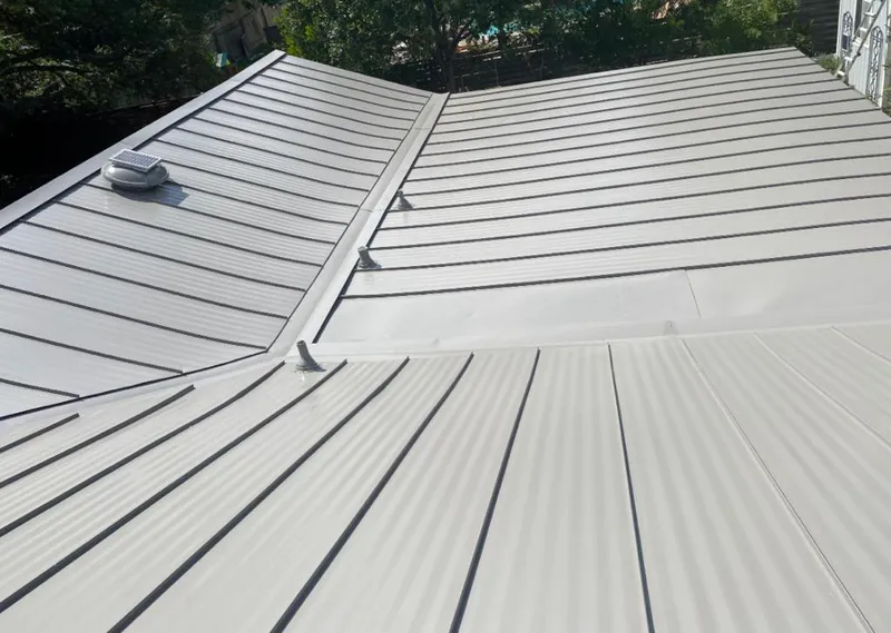 Solar attic fan installed on a metal roof for Roof Ventilation in Destrehan